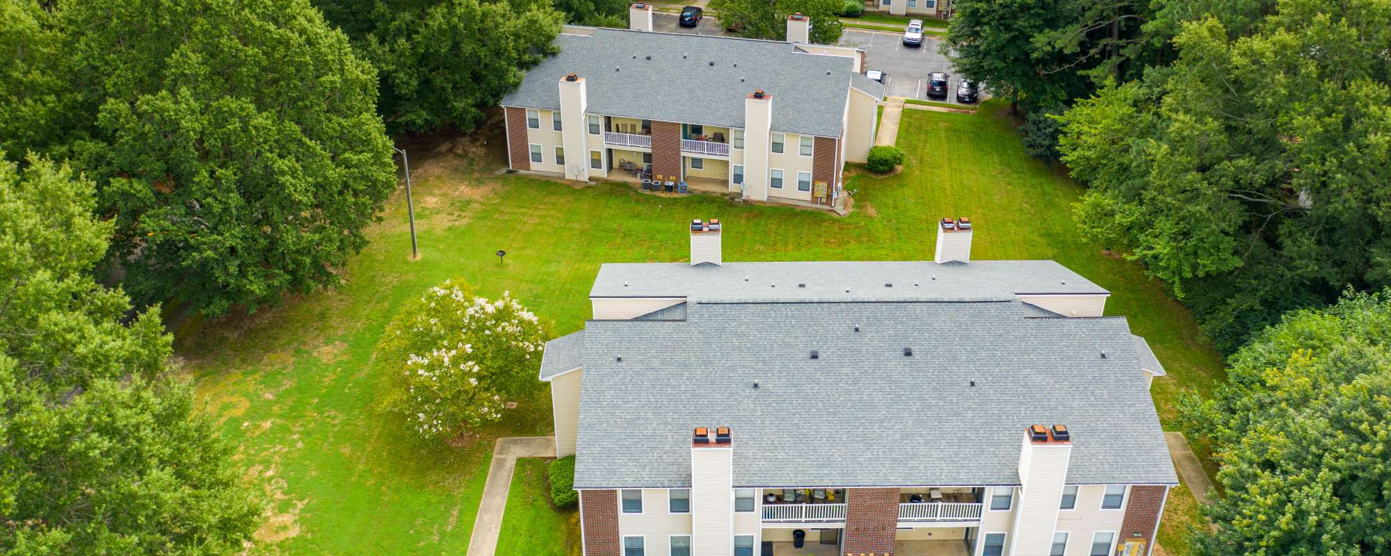 Garden-style Bryan Woods apartment homes surrounded by mature trees